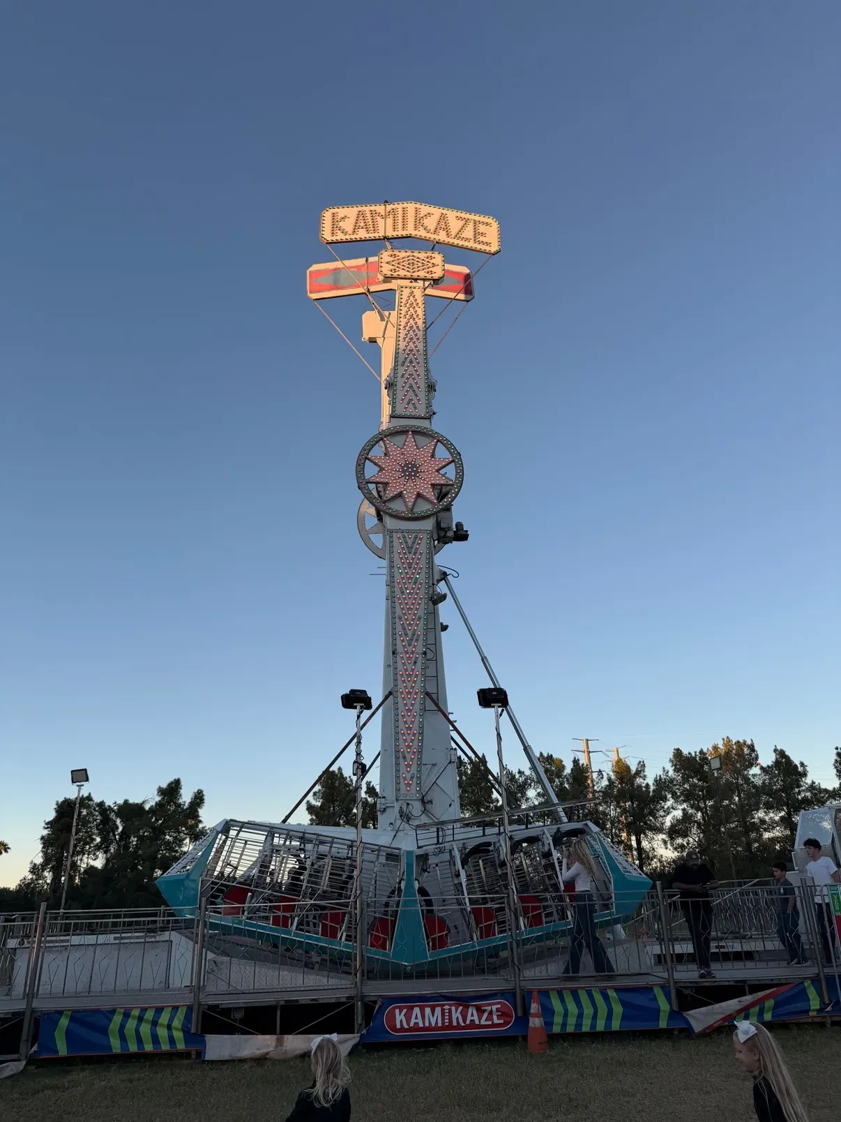 The Kamikaze pendulum ride towering against the dusk sky
